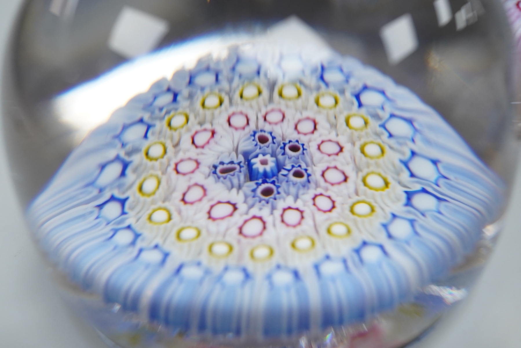Two millefiori glass paperweights and an inkwell, 12cm high